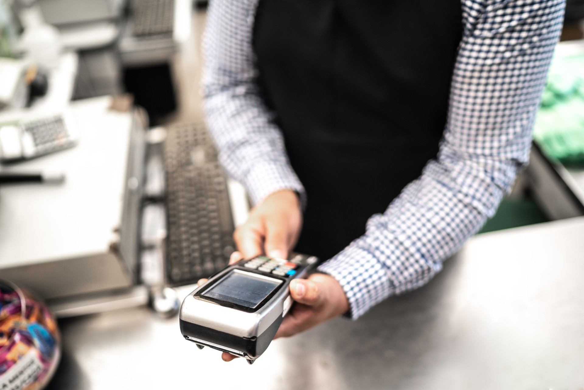 Man accepting payment by card on supermarket